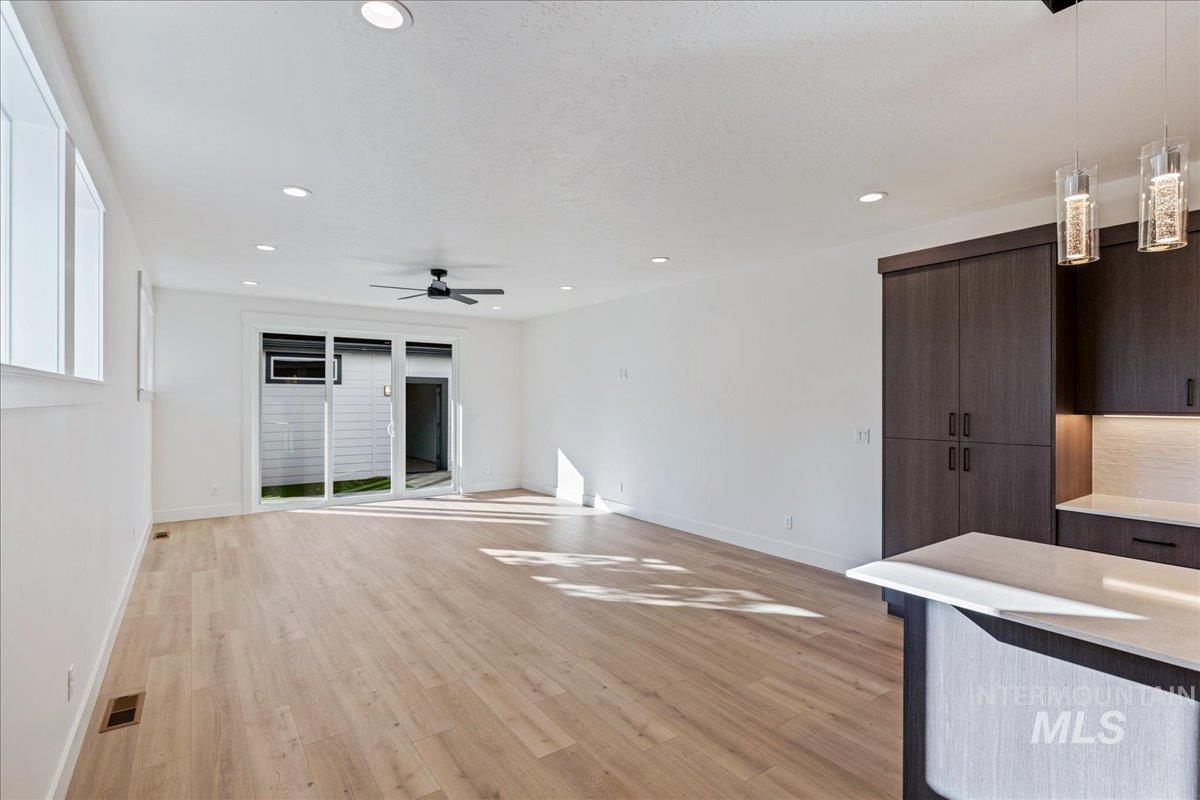 Unfurnished living room featuring light wood-type flooring, recessed lighting, and ceiling fan