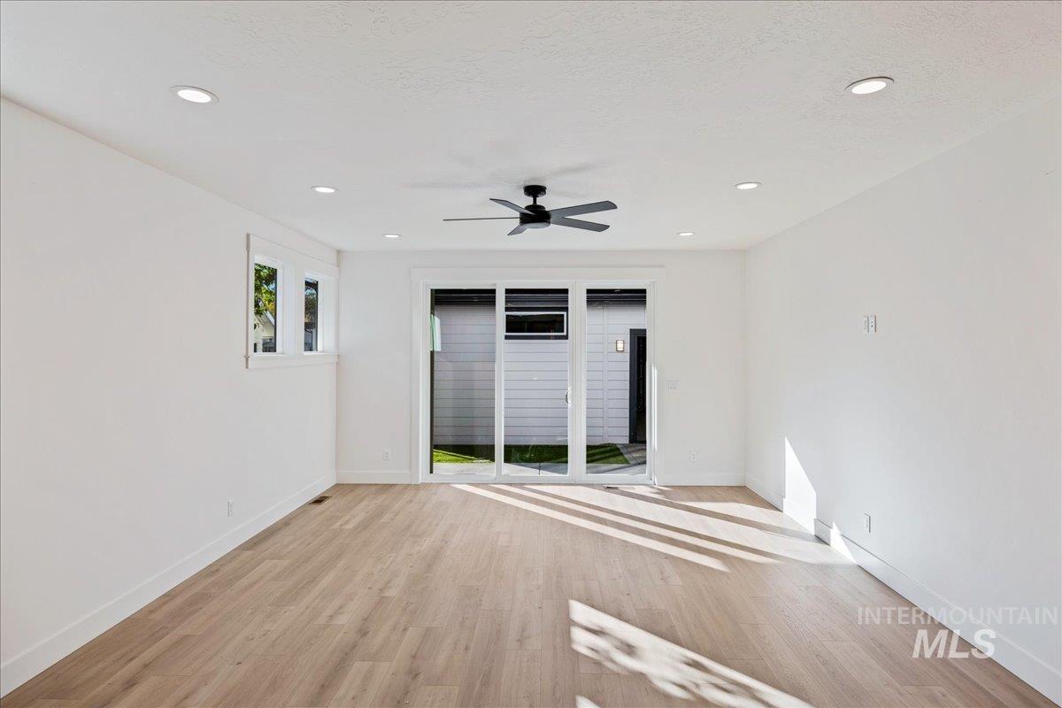 Unfurnished room with light wood-style flooring, recessed lighting, and a ceiling fan