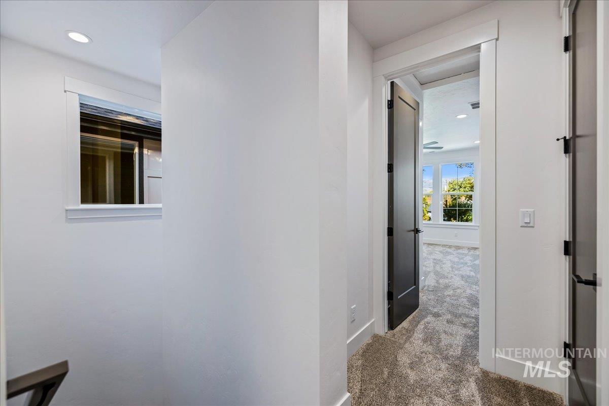Corridor featuring carpet and recessed lighting