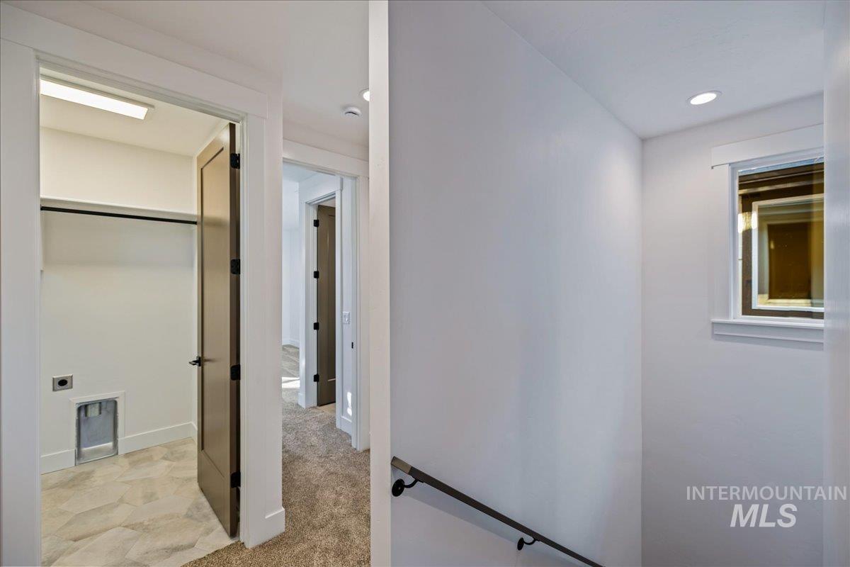 Hall featuring light colored carpet and recessed lighting