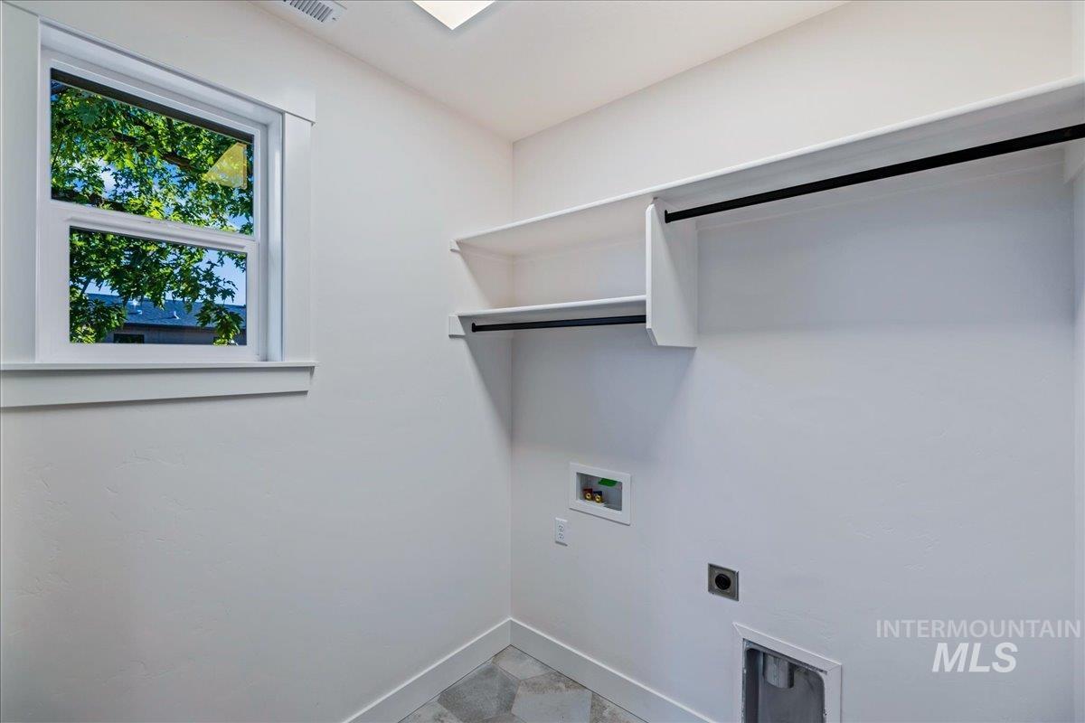 Washroom featuring electric dryer hookup and hookup for a washing machine