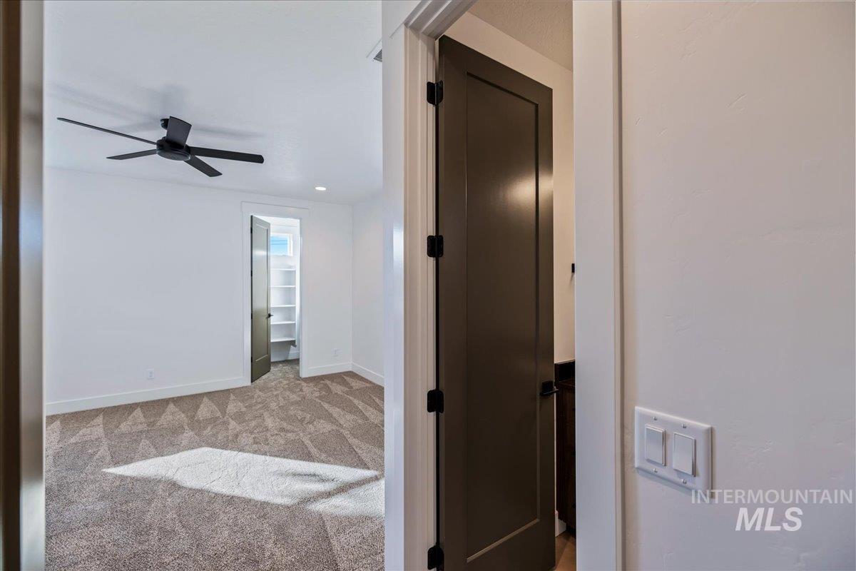 Corridor featuring light colored carpet and recessed lighting