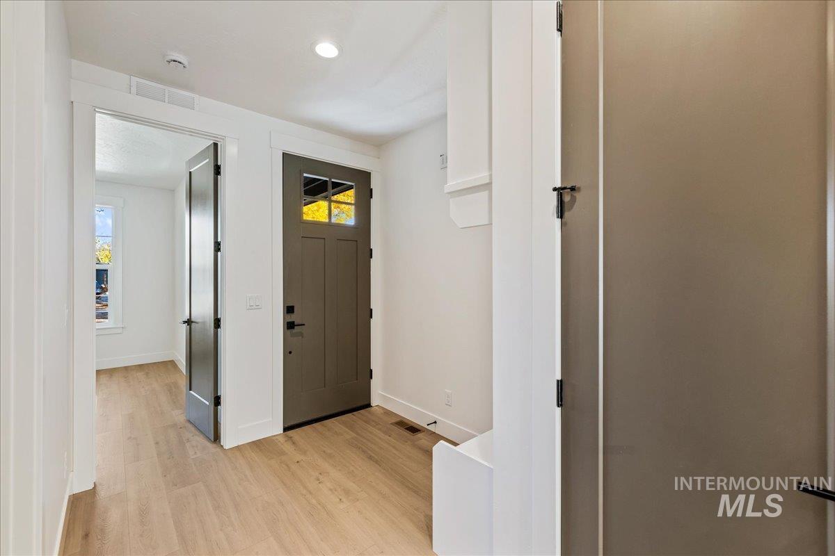 Entryway featuring light wood-type flooring and recessed lighting
