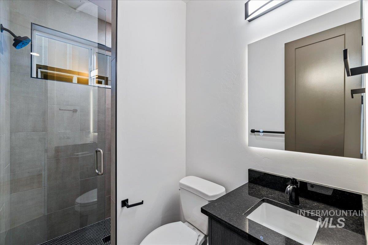 Bathroom featuring vanity and a stall shower
