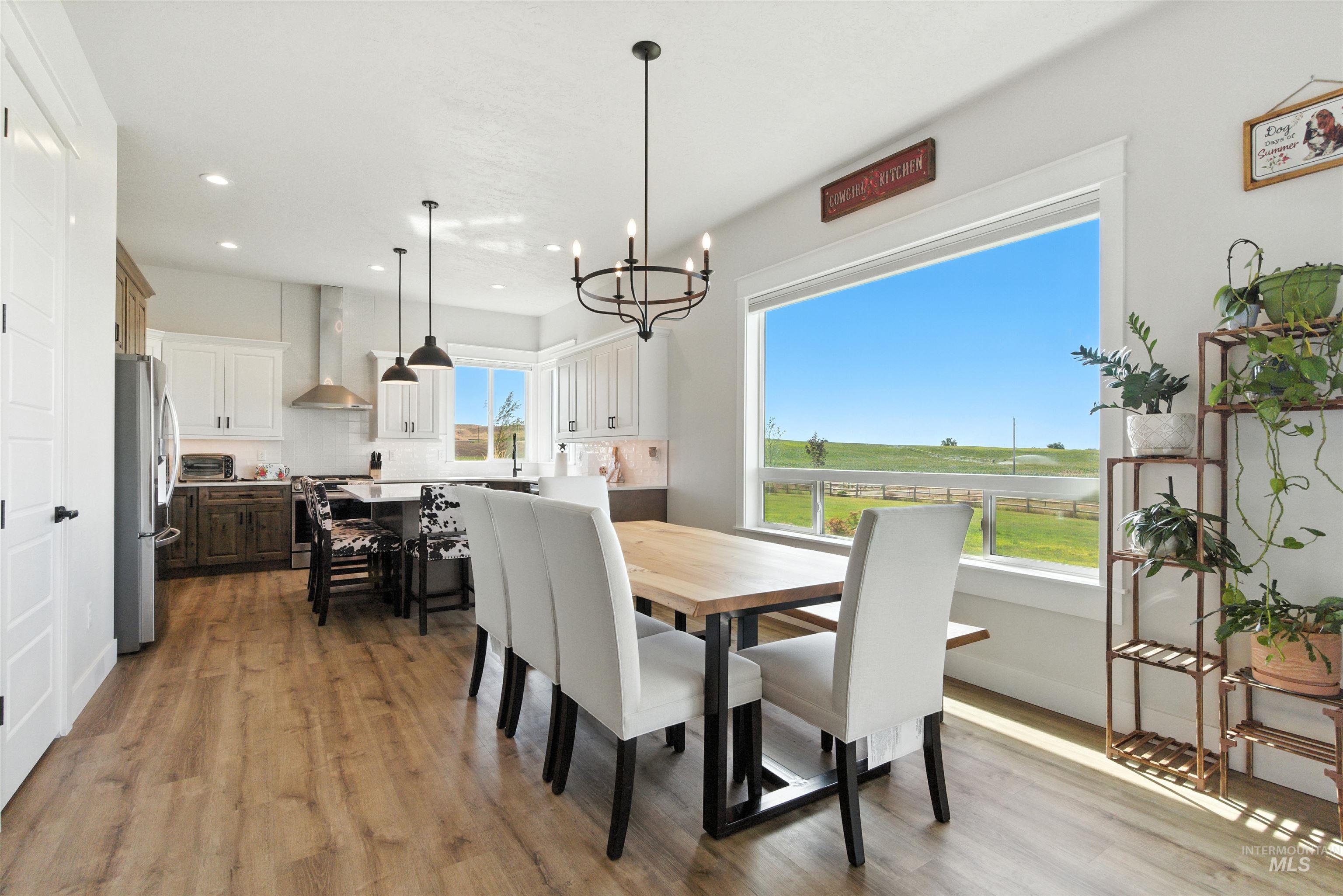 Dining space featuring light wood-style floors, recessed lighting, and a chandelier