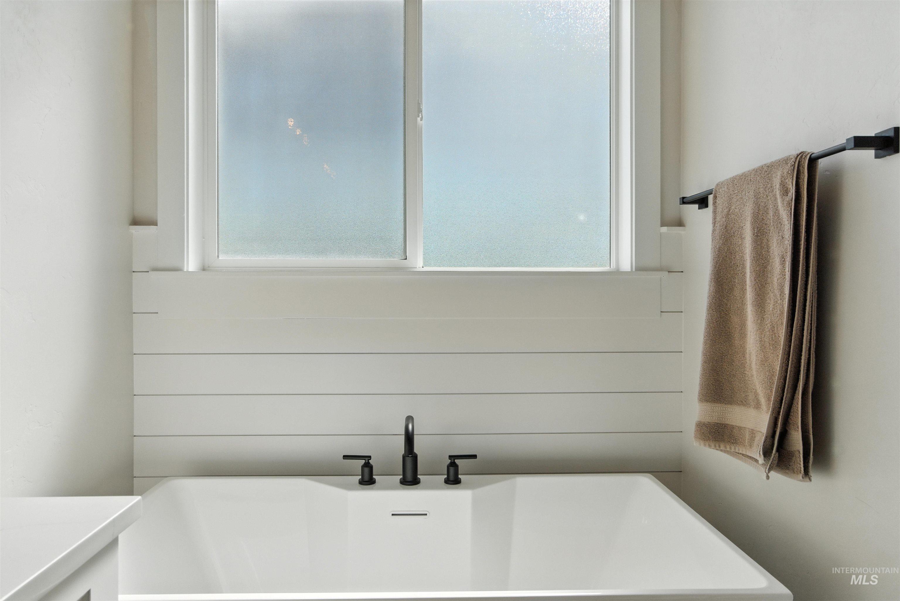 Bathroom with a freestanding tub and a sink