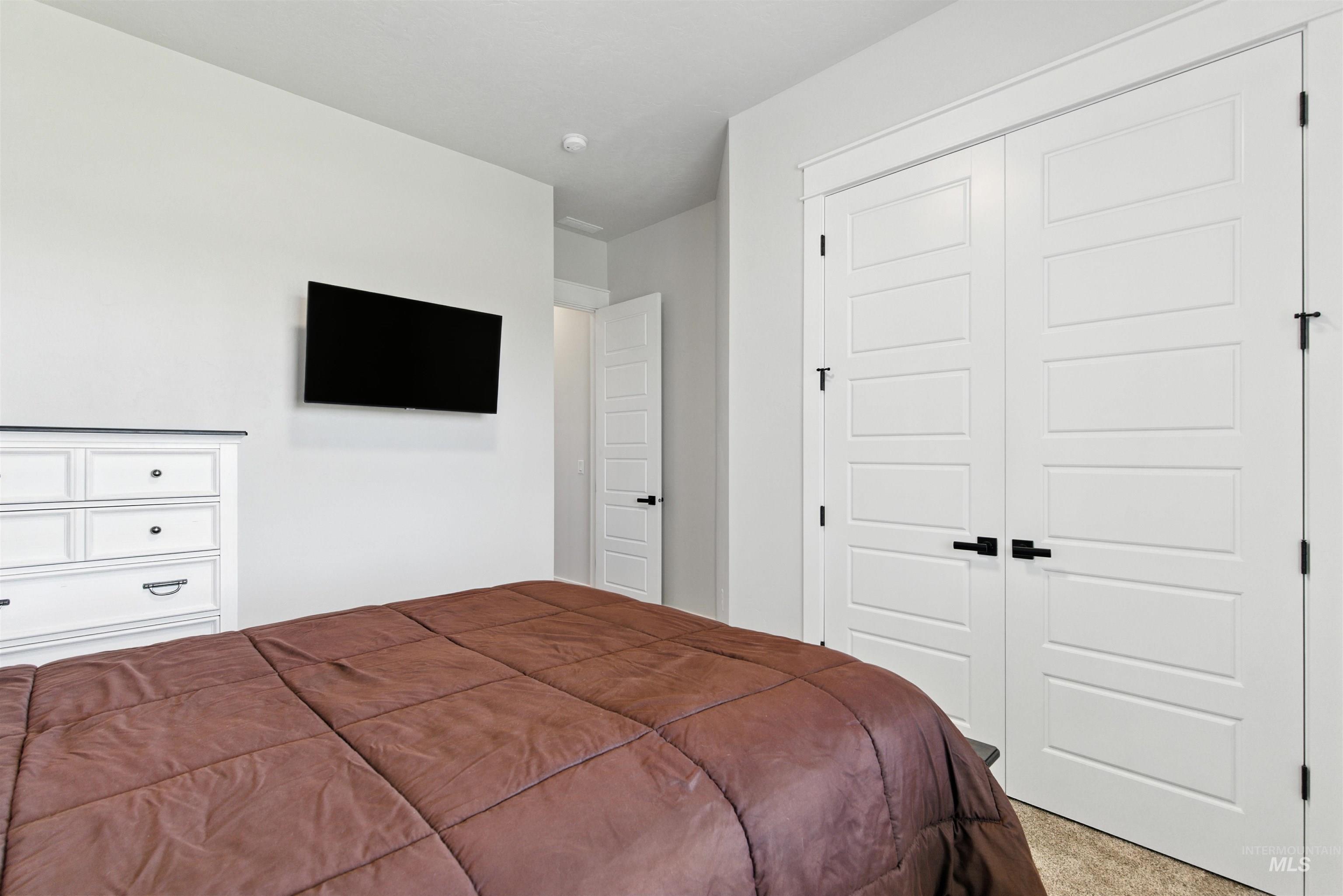 Bedroom with a closet and light carpet