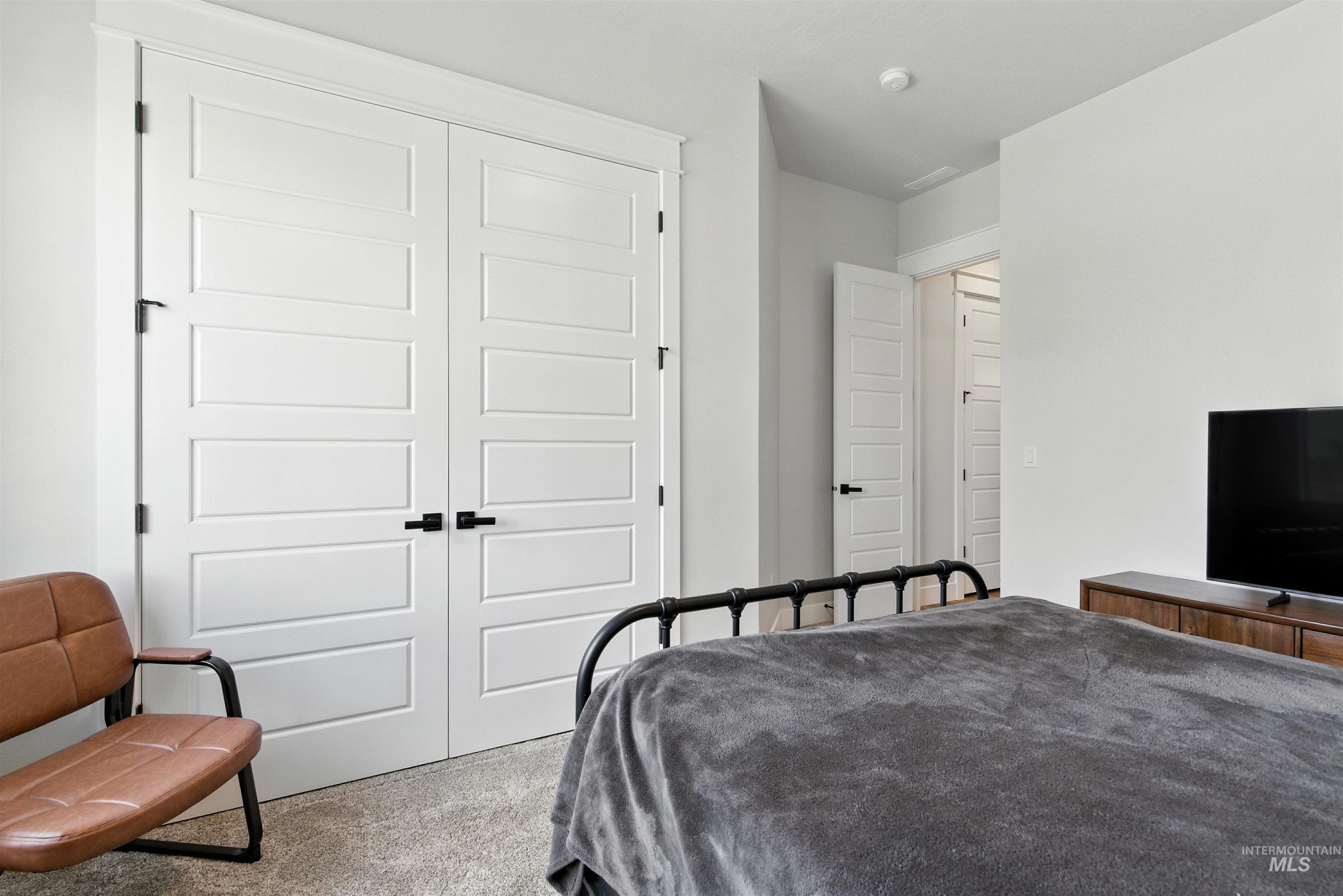Carpeted bedroom featuring a closet