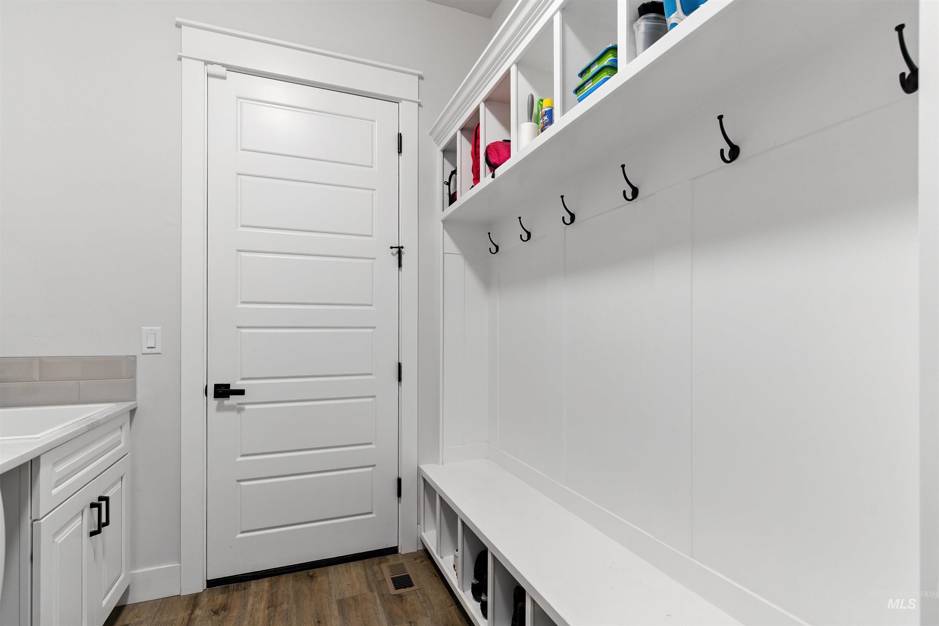 Mudroom with dark wood-style floors