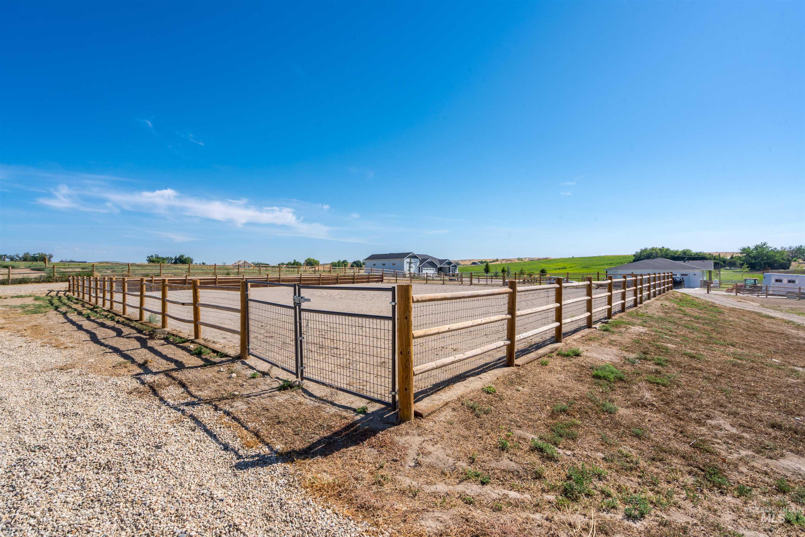 View of yard with a rural view and an outdoor riding arena