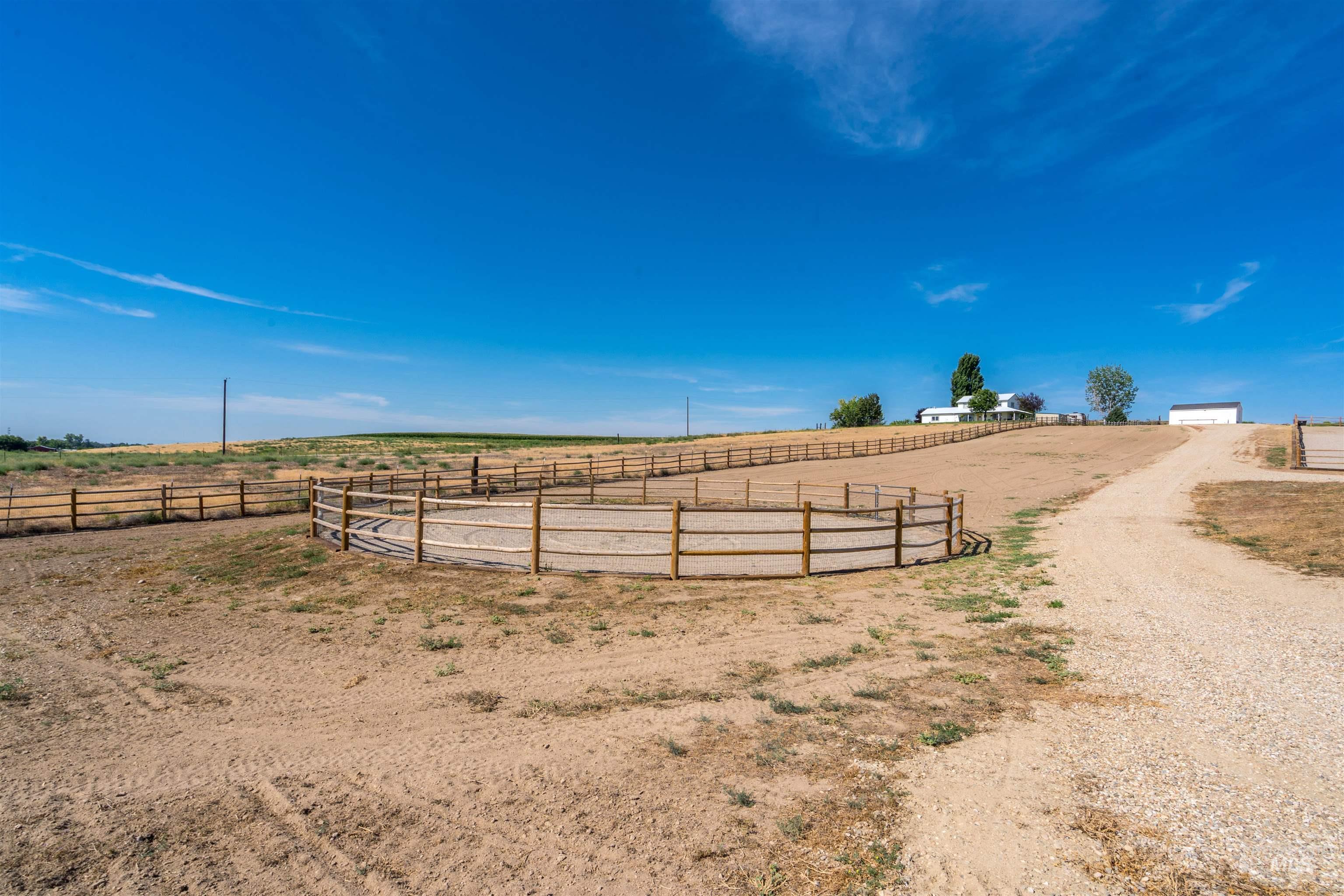 View of yard featuring an outdoor riding arena and a rural view