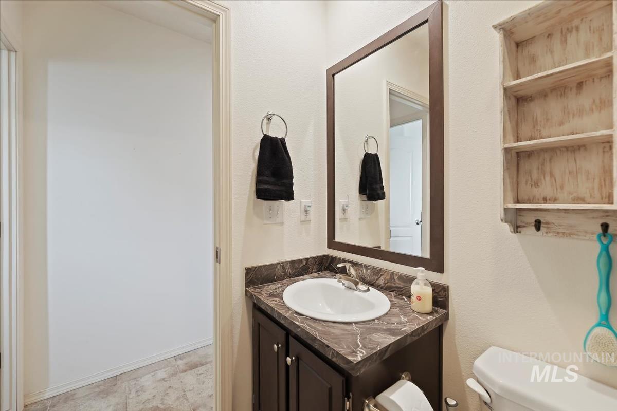 Bathroom with vanity and a textured wall