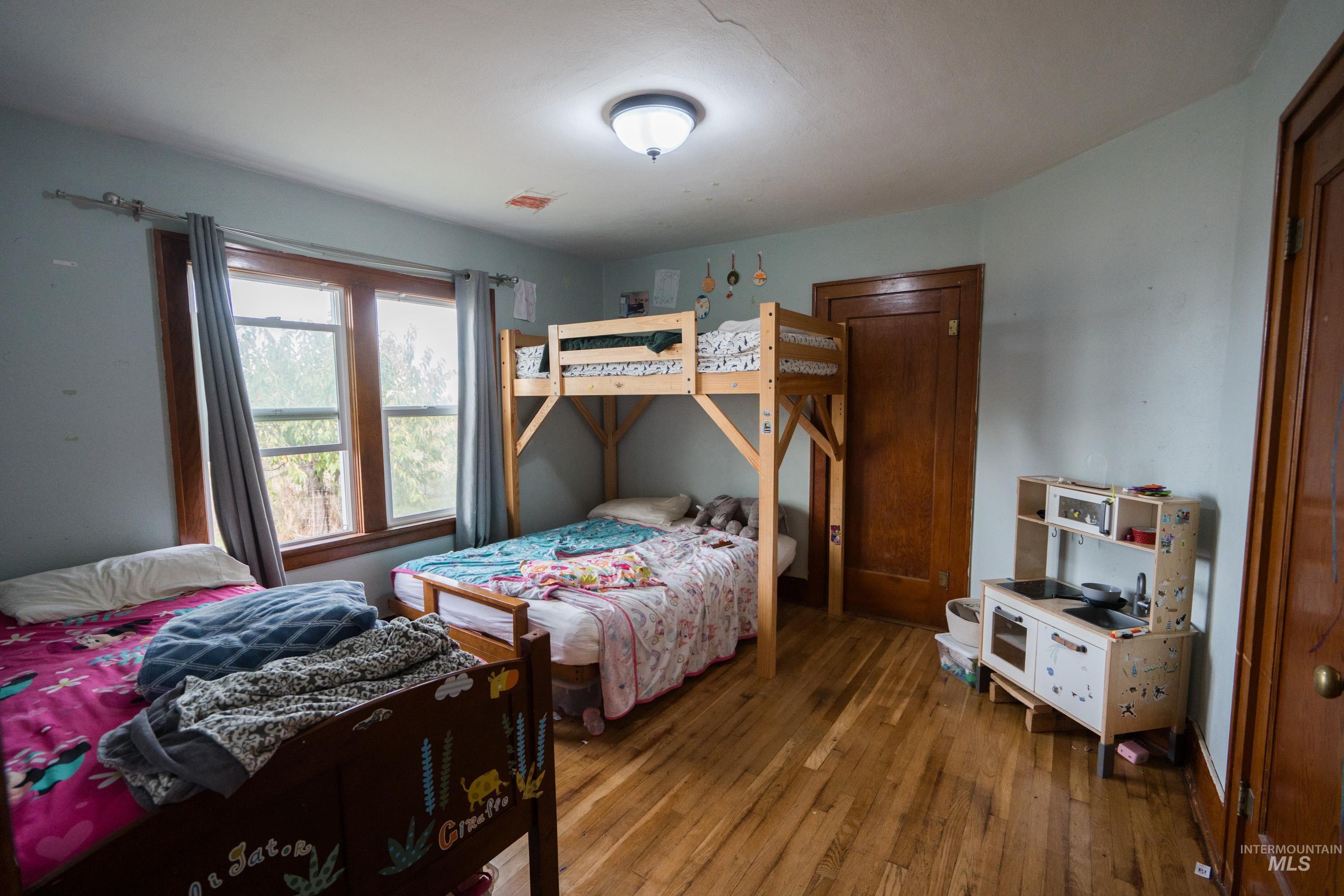 Bedroom with hardwood / wood-style flooring