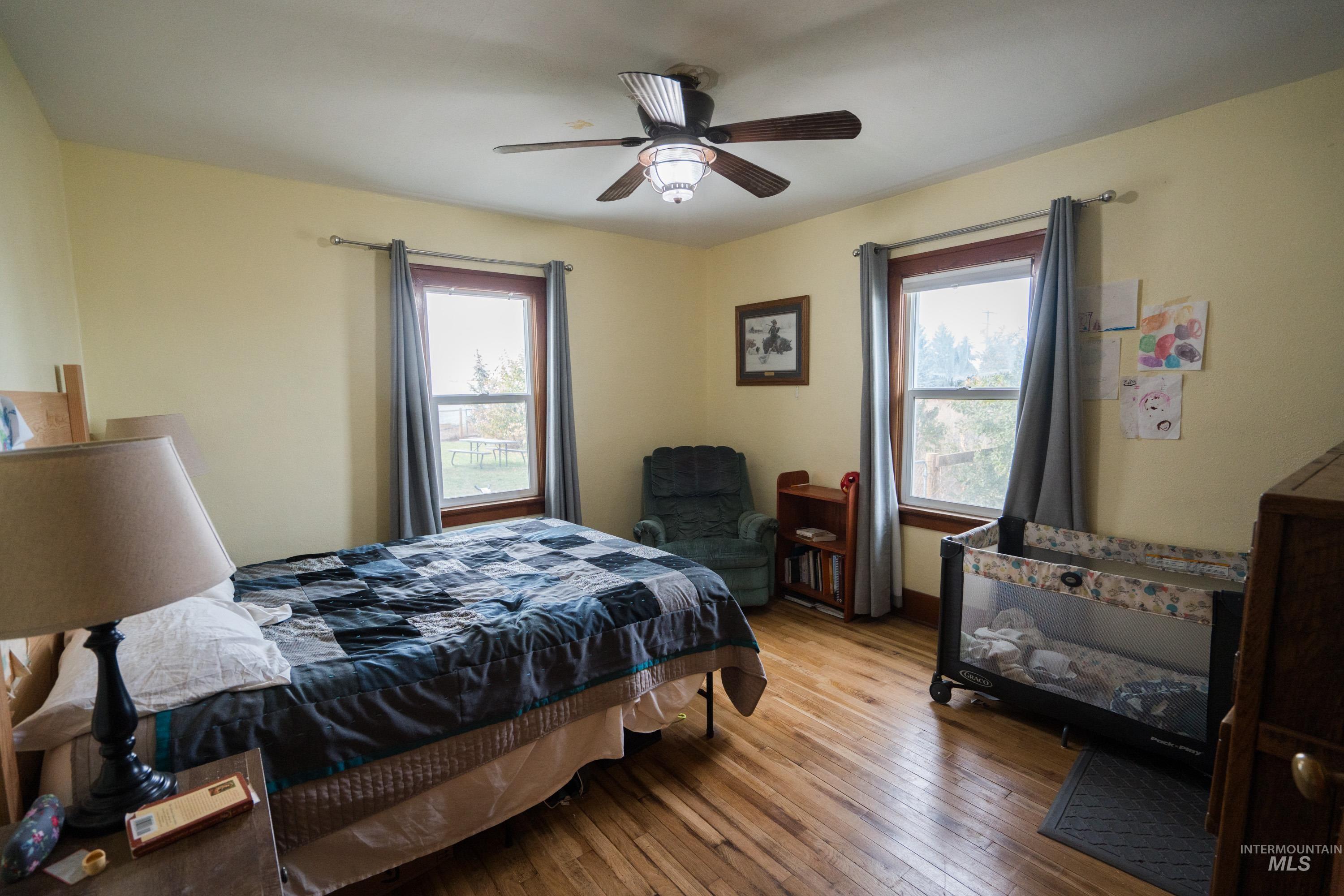 Bedroom featuring wood-type flooring and ceiling fan