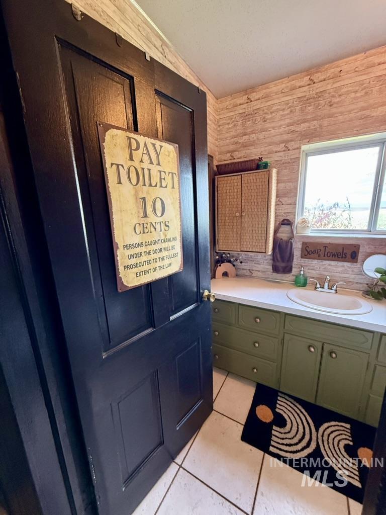 Bathroom featuring vanity and light tile patterned floors