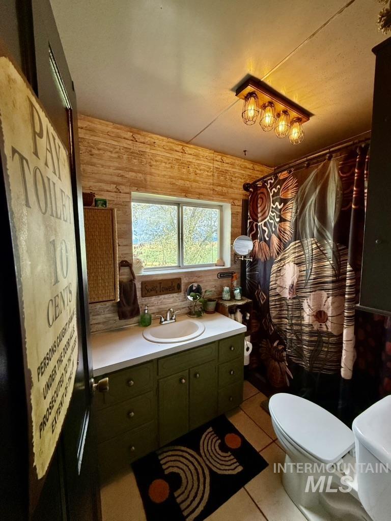 Bathroom with vanity, light tile patterned floors, a shower with shower curtain, and tasteful backsplash