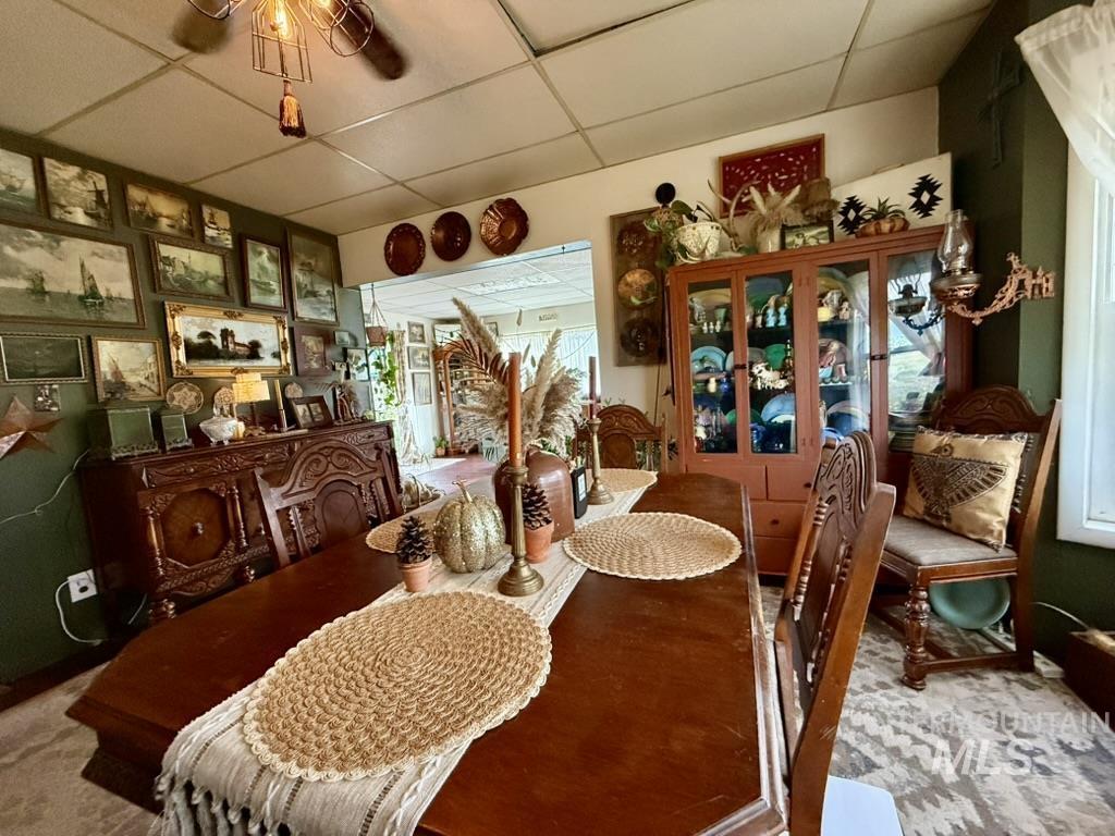 Dining room with a paneled ceiling and carpet floors
