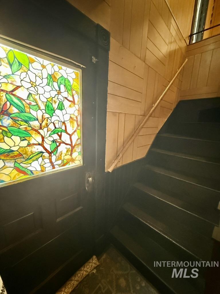 Doorway to outside with stairs and wooden walls