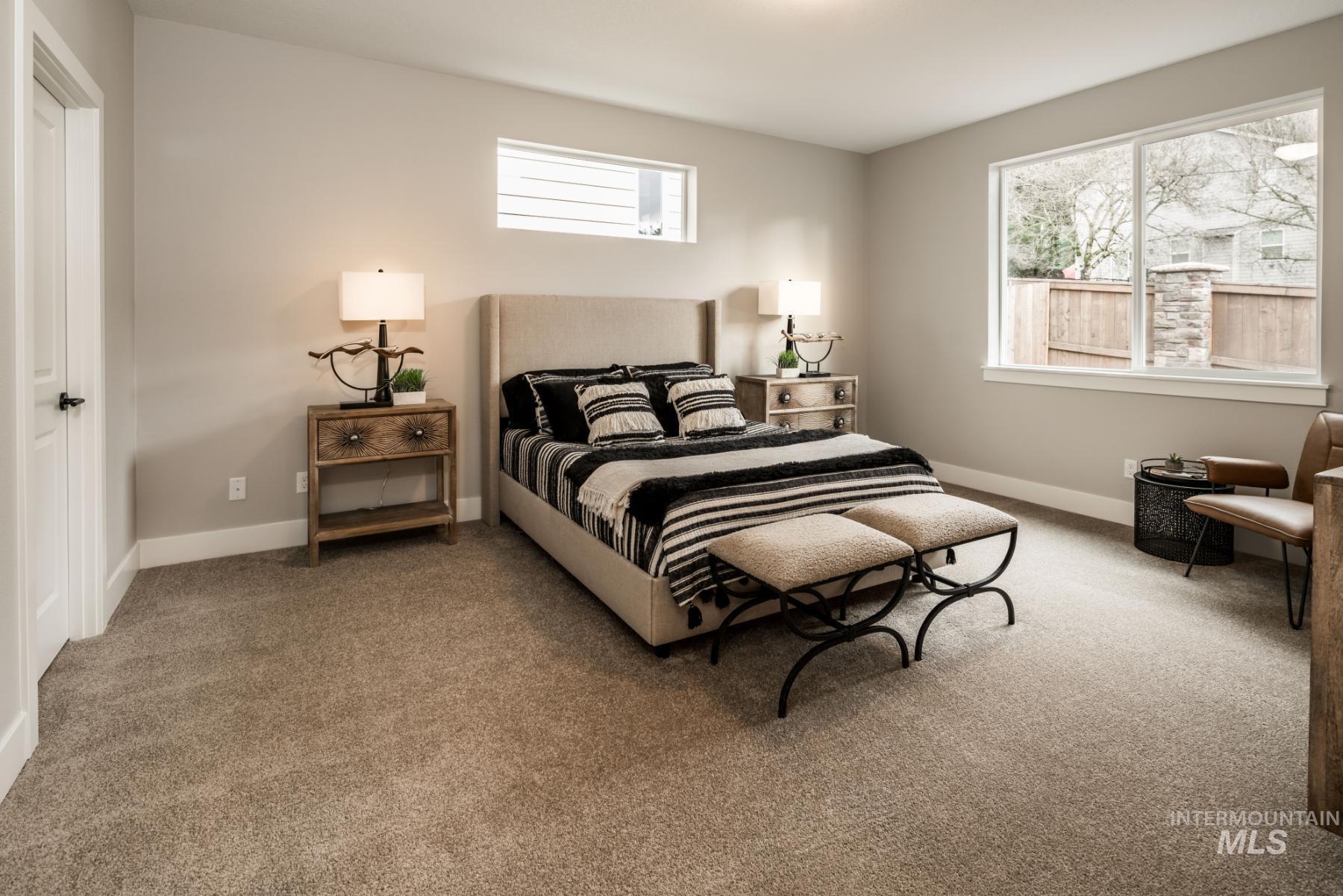 Carpeted bedroom featuring baseboards