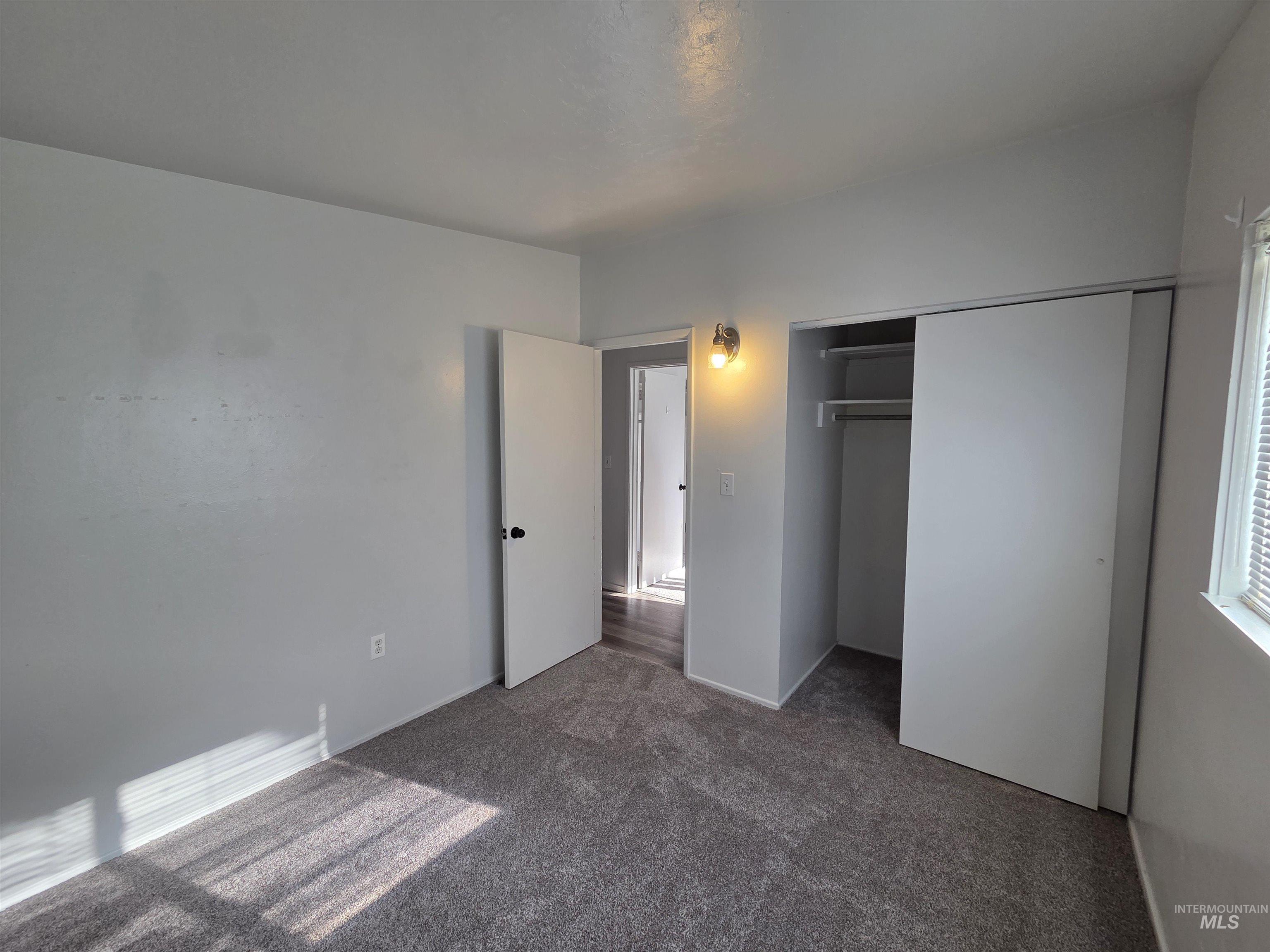 Unfurnished bedroom with carpet floors and a closet