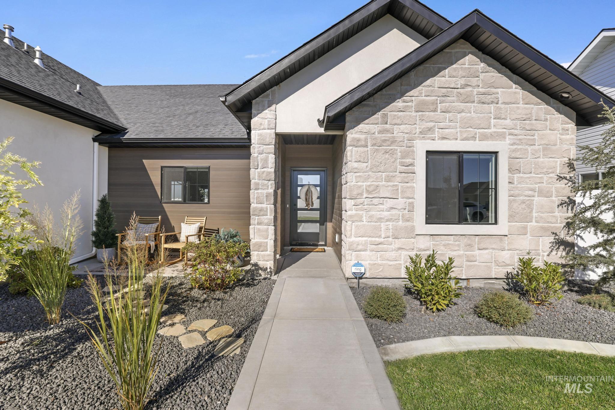 View of exterior entry featuring stone siding