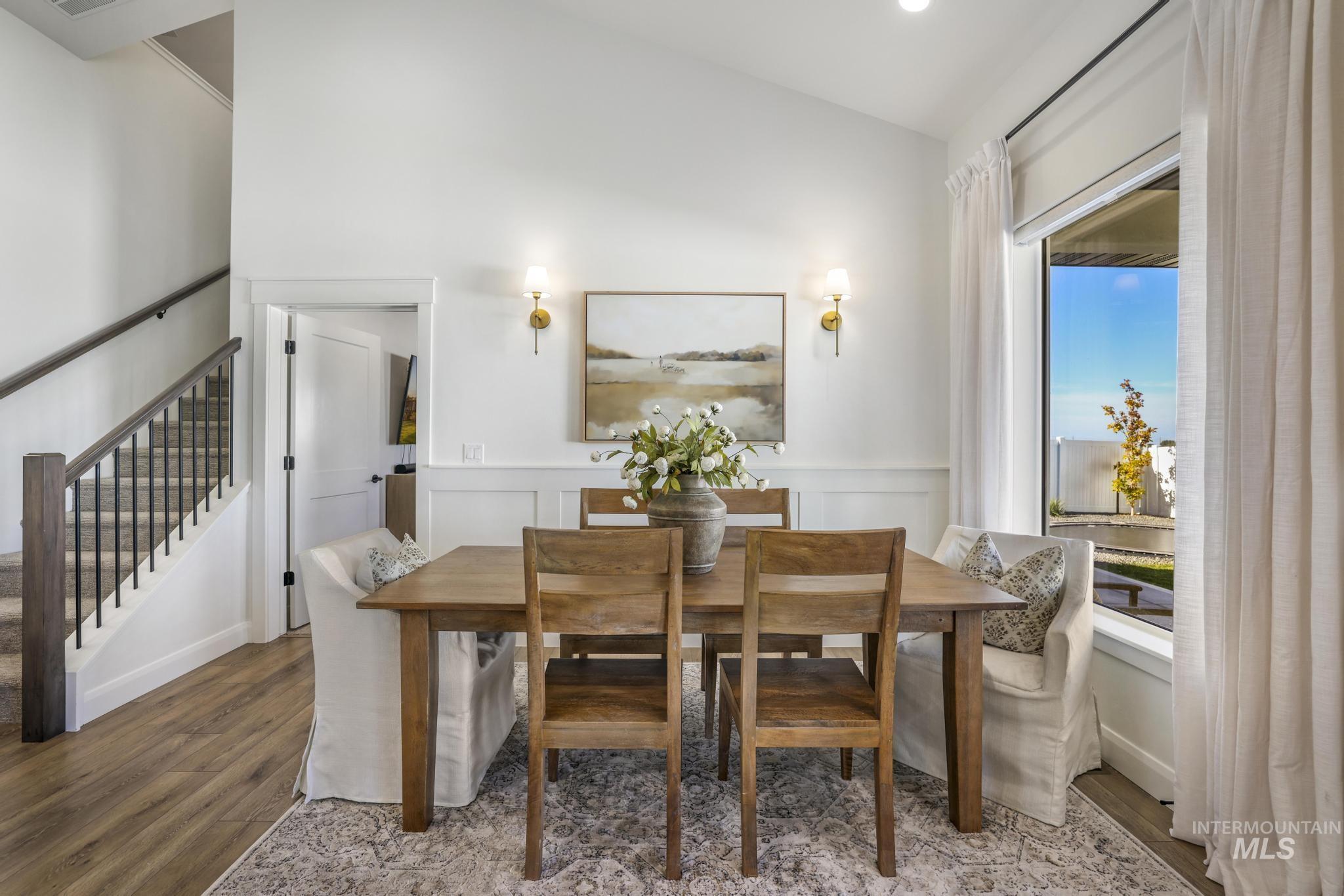 Dining room featuring wood finished floors and stairs