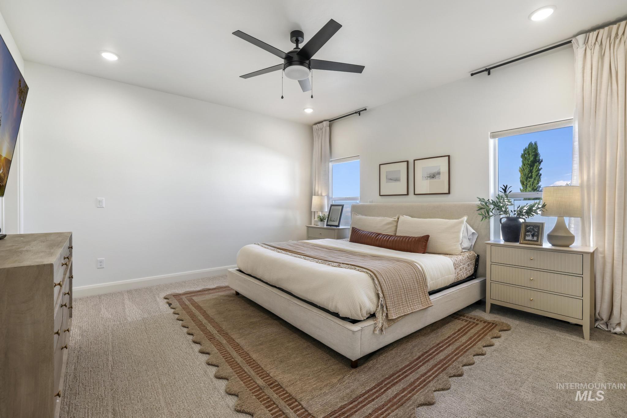 Bedroom featuring light carpet, ceiling fan, and recessed lighting