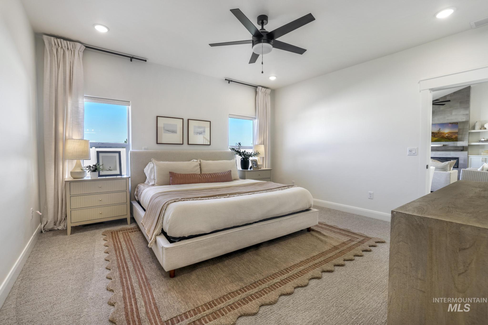 Bedroom featuring light carpet, ceiling fan, and recessed lighting
