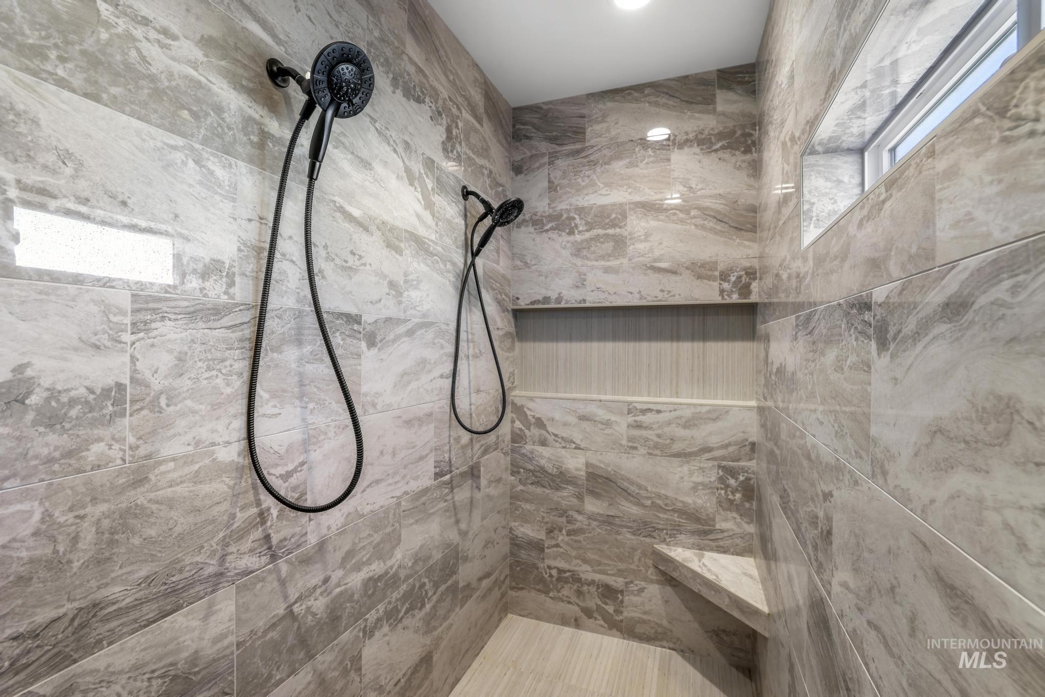 Bathroom featuring a marble finish shower