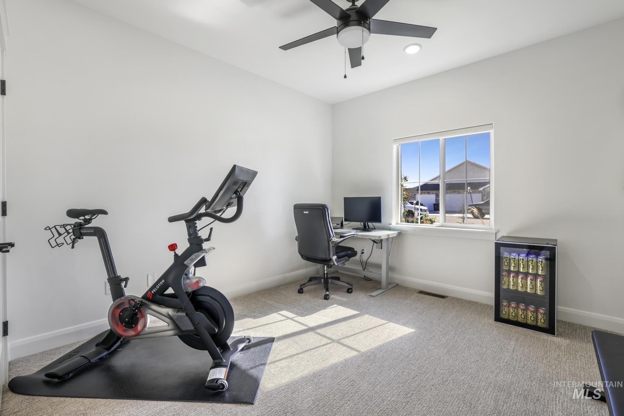 Carpeted office featuring a ceiling fan and recessed lighting