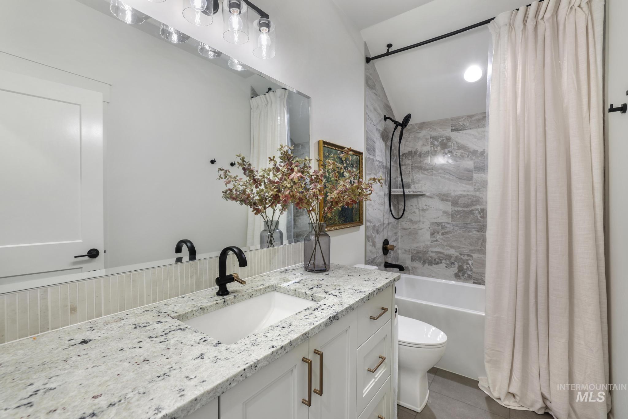 Bathroom featuring shower / bath combo and vanity