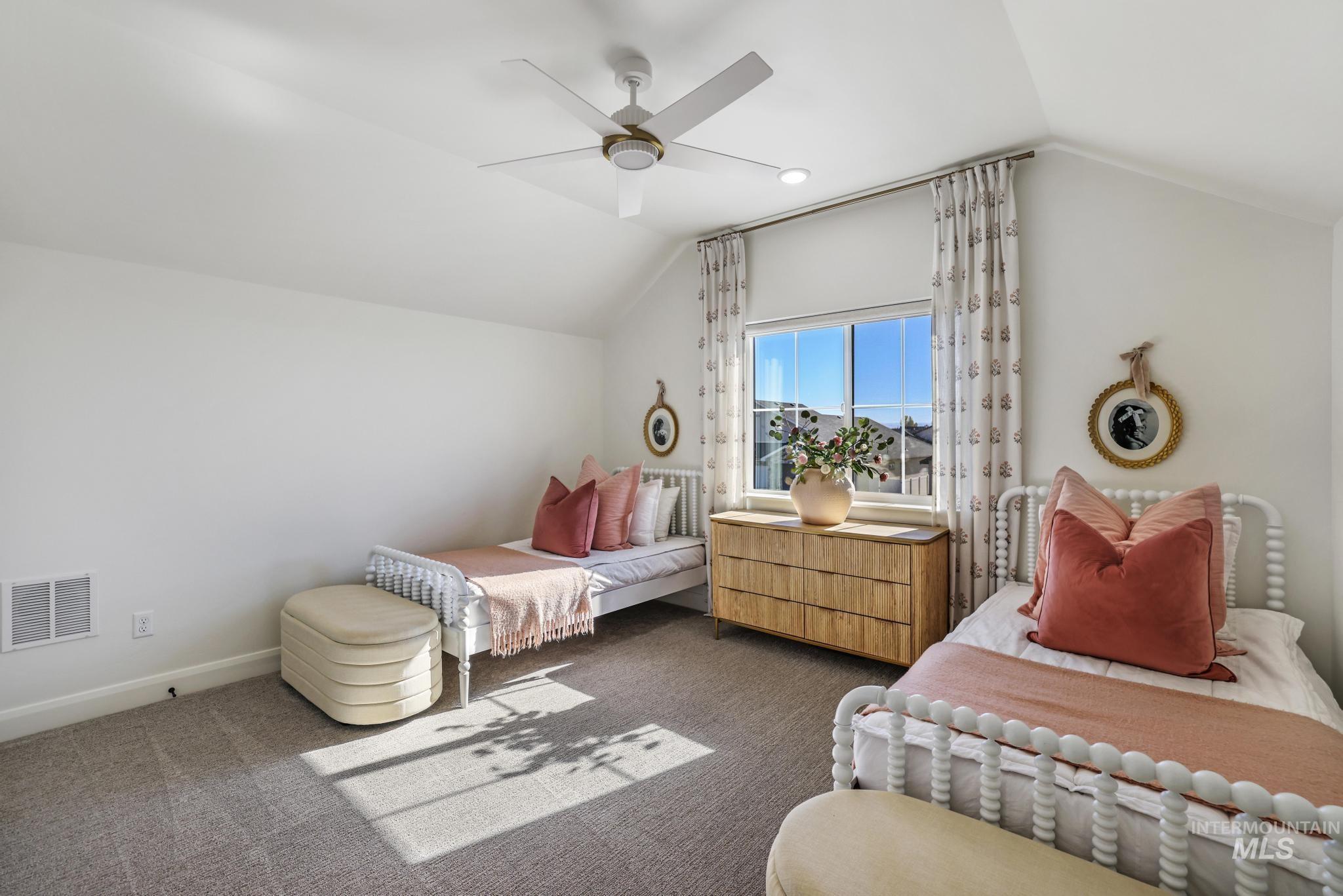 Bedroom featuring lofted ceiling, carpet flooring, and ceiling fan