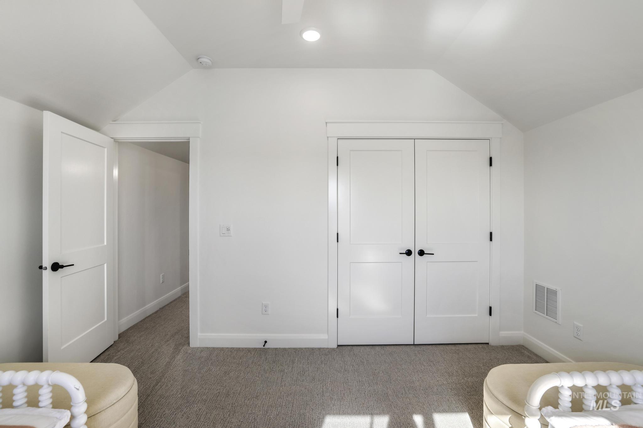 Bedroom featuring carpet floors, vaulted ceiling, a closet, and recessed lighting