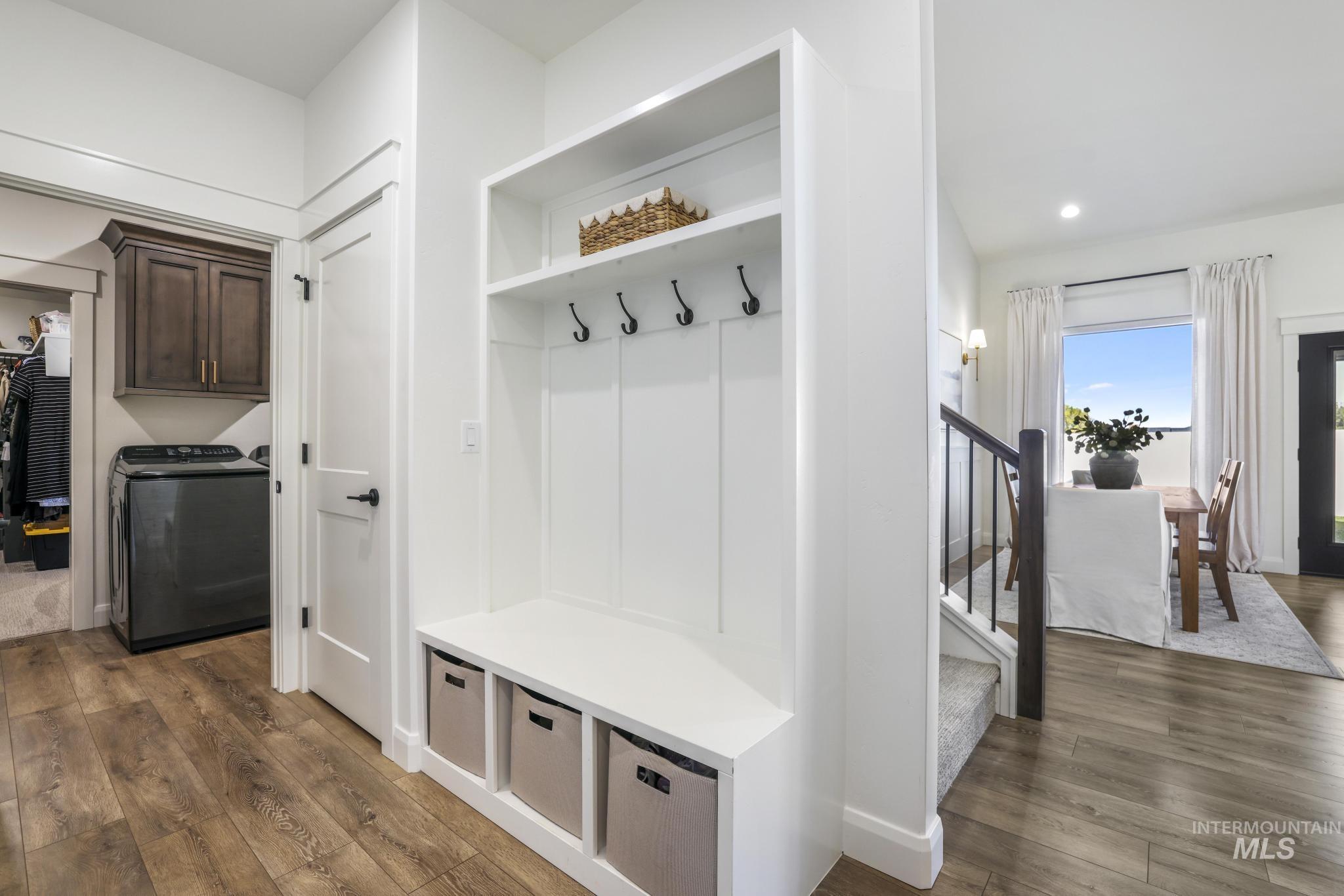 Mudroom with dark wood-style floors, washer / clothes dryer, and recessed lighting