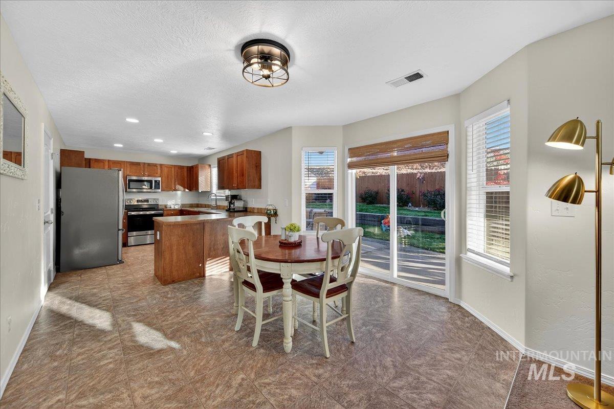 Dining area with a textured ceiling and recessed lighting