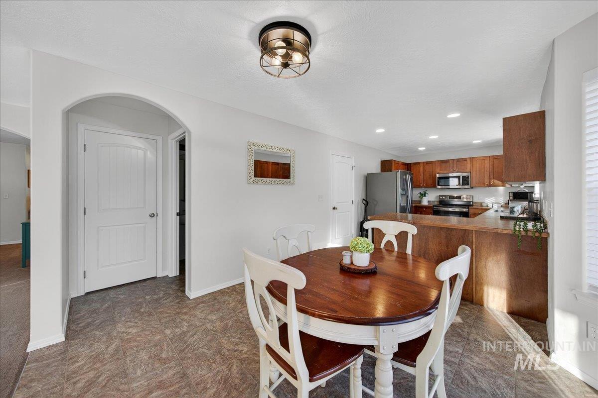 Dining area with recessed lighting and arched walkways
