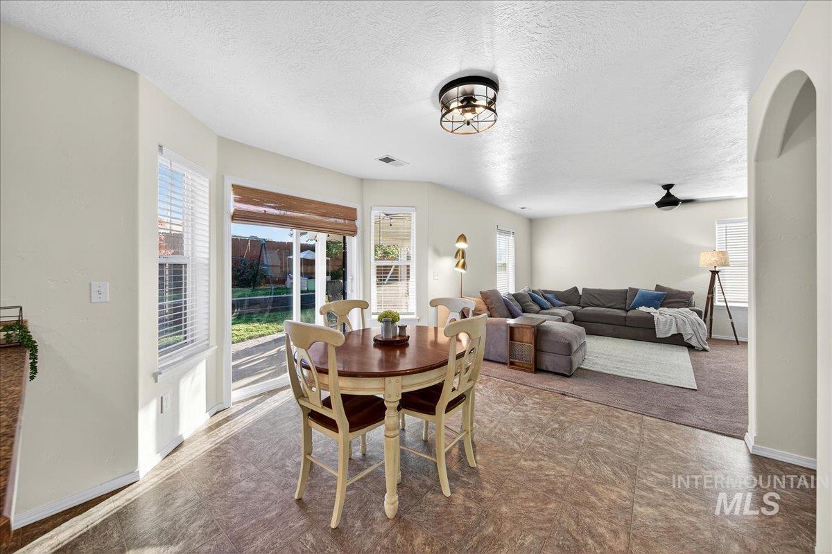 Dining space featuring a textured ceiling and baseboards