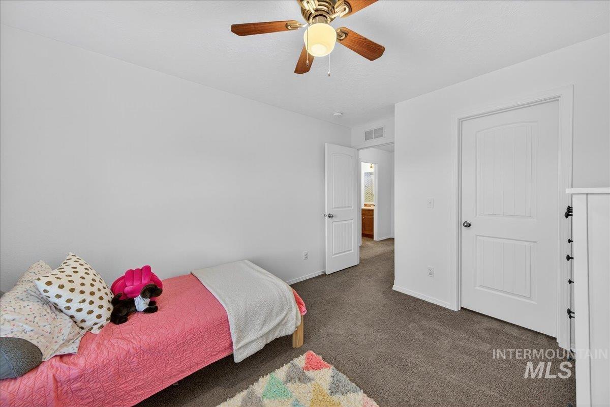 Bedroom featuring carpet flooring and ceiling fan