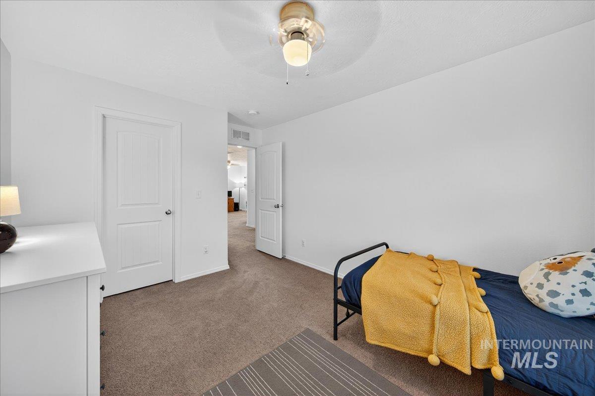 Bedroom featuring carpet and ceiling fan