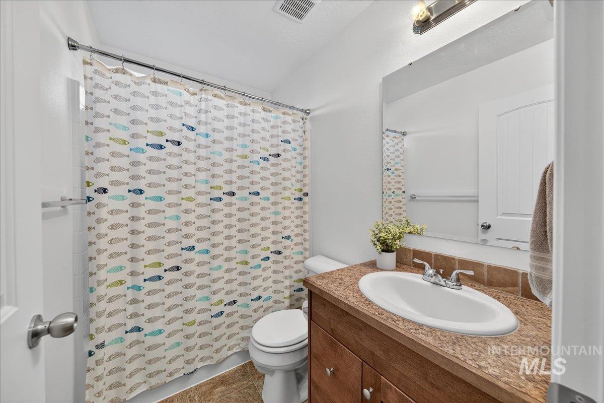 Full bathroom featuring vanity and curtained shower