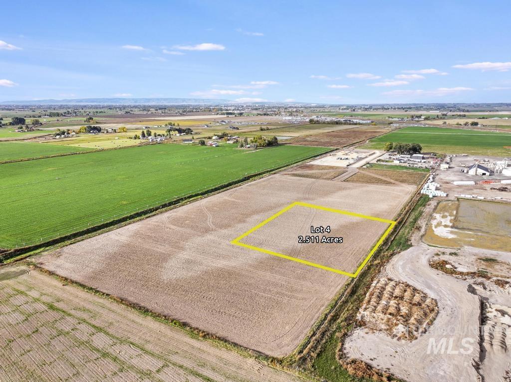 Overview of rural landscape featuring large plots for crops and property parcel outlined