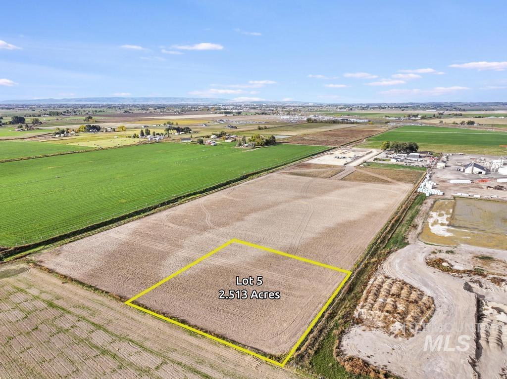 Aerial view of sparsely populated area featuring farmland and property parcel outlined