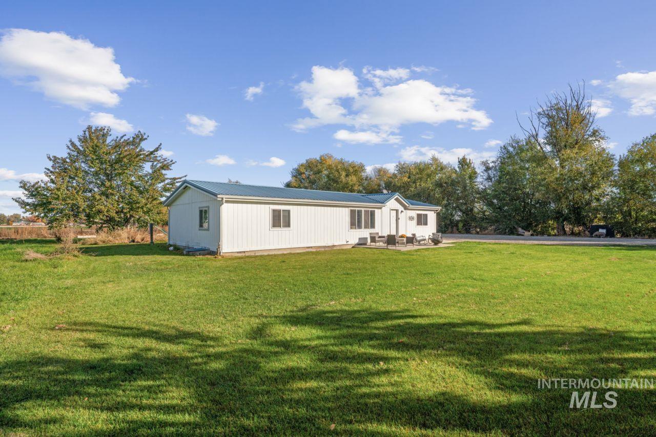 Back of property with a yard and a patio