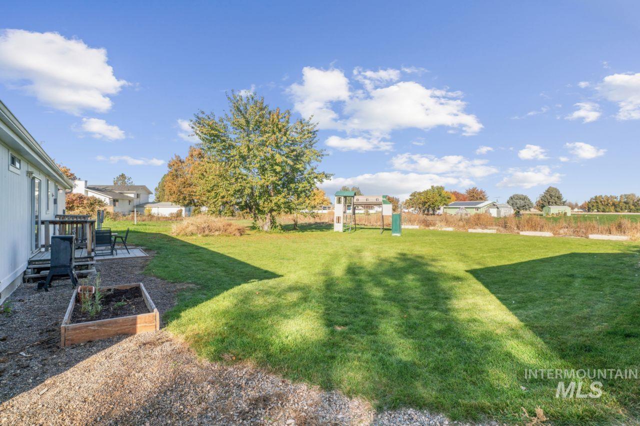 View of yard featuring a garden, a patio area, and a playground