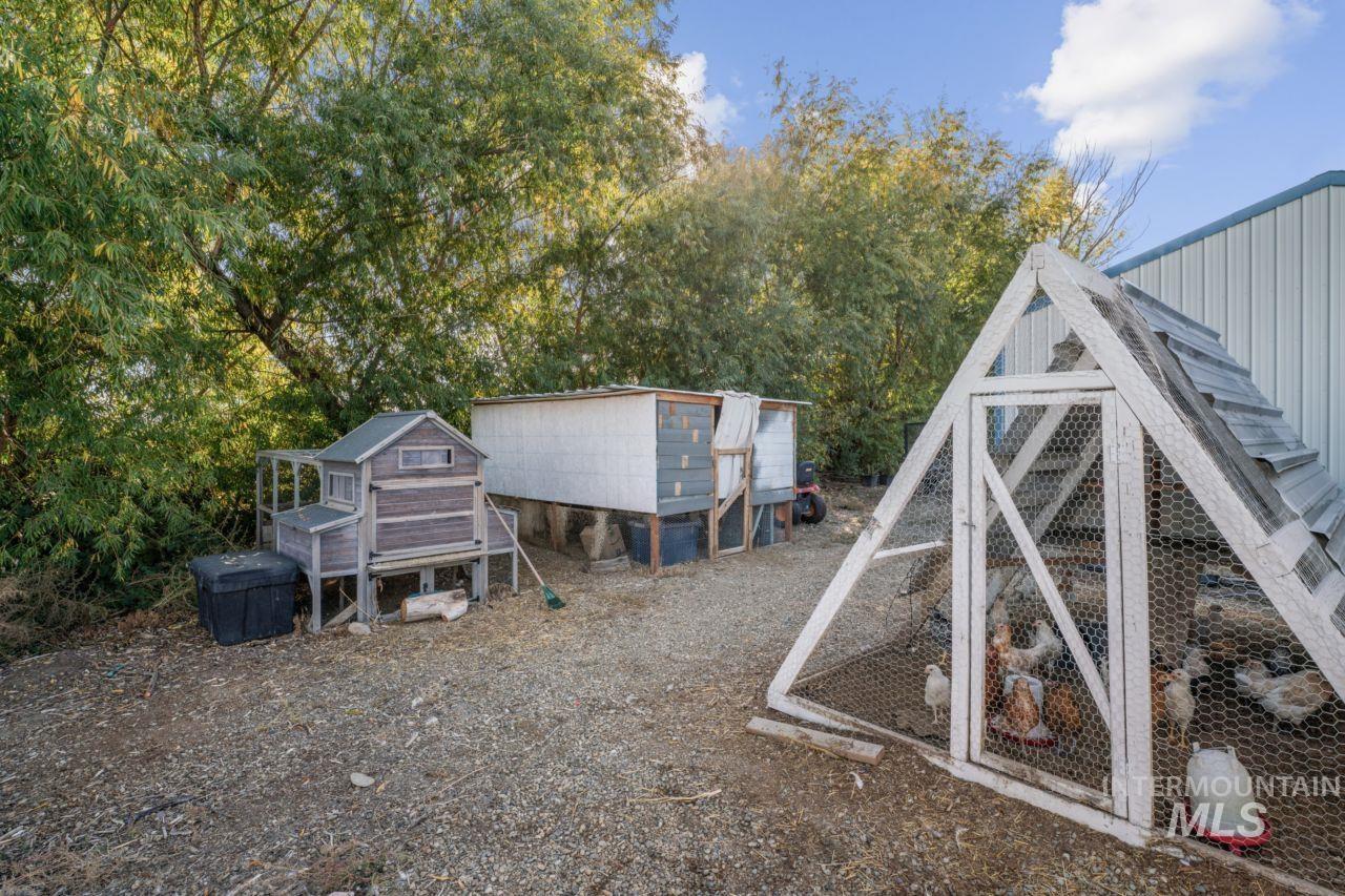 View of yard featuring exterior structure, an outdoor structure, and a wooden deck