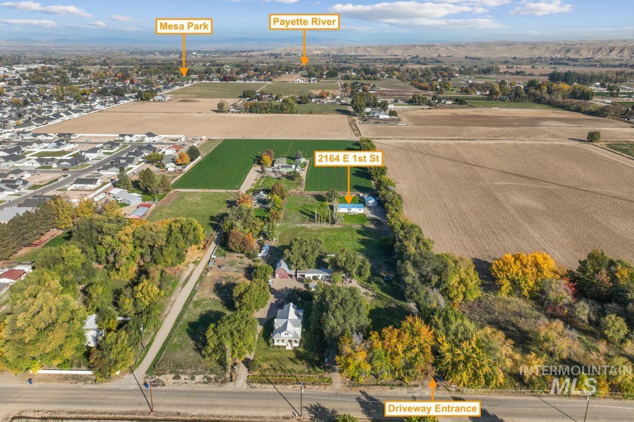 Aerial view of property and surrounding area featuring rural landscape and abundant farmland
