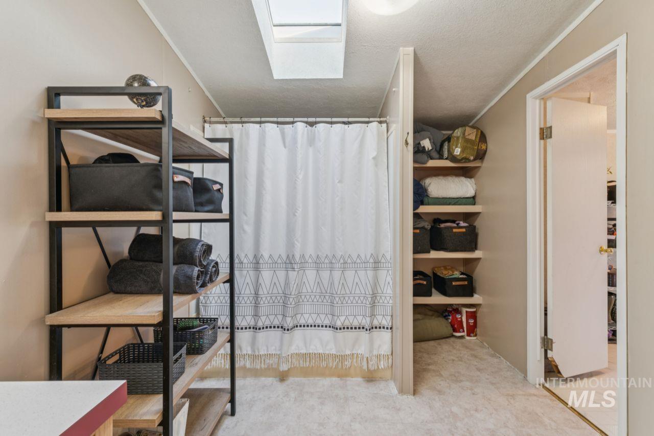 Walk in closet featuring a skylight