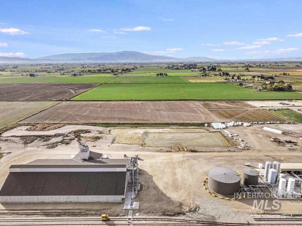 Overview of rural landscape with a mountain backdrop and farmland