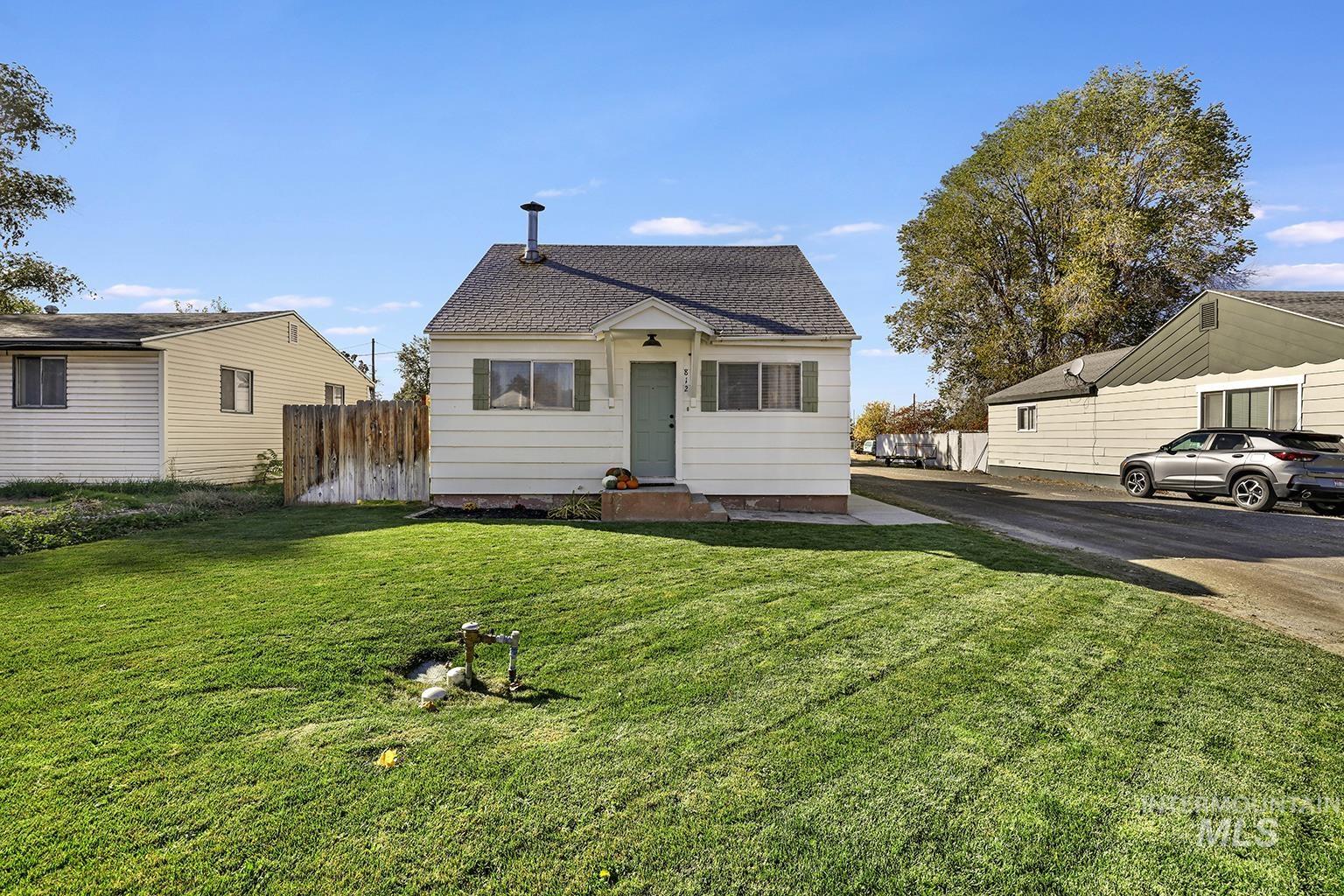 Bungalow-style home with a shingled roof