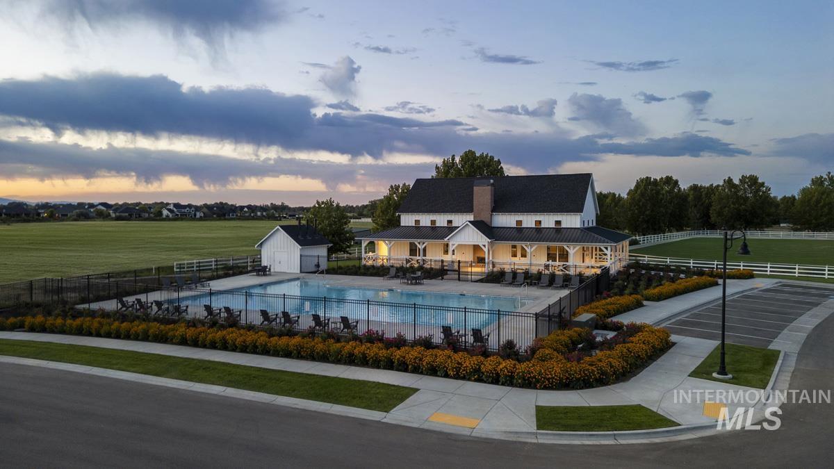 Community pool featuring a patio and an outbuilding